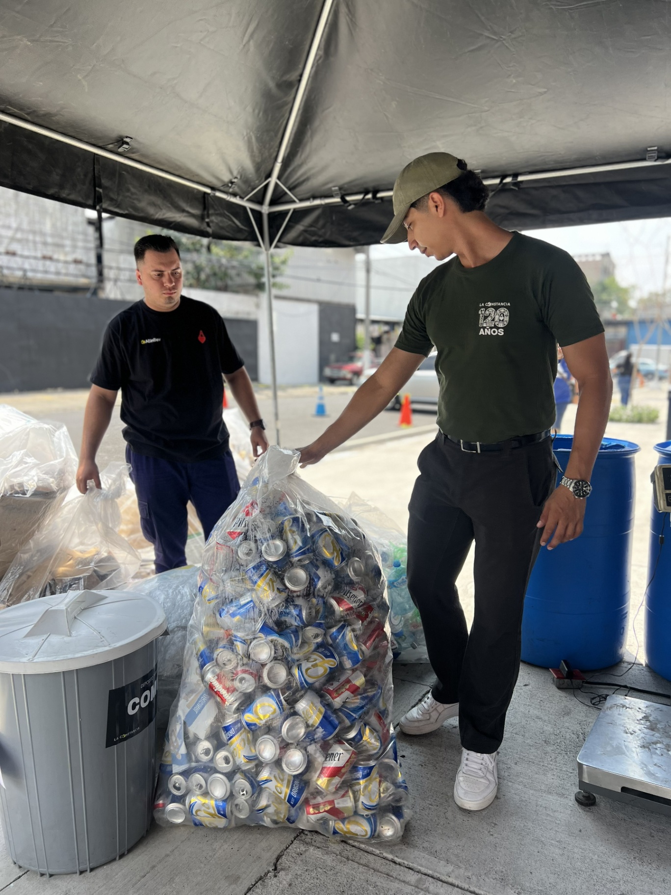 Participante entregando latas en campaña Recicla y Gana